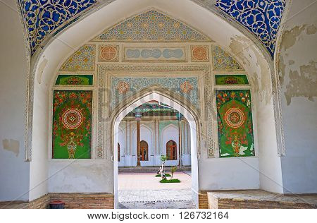 KOKAND UZBEKISTAN - MAY 6 2015: The entrance gate of Khudayar Khan Palace with decorated plaster walls on May 6 in Kokand.