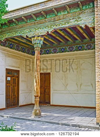KOKAND UZBEKISTAN - MAY 6 2015: The cozy terrace of the Khudayar Khan Palace decorated with the slender wooden pillar and the carved and painted ceiling on May 6 in Kokand.