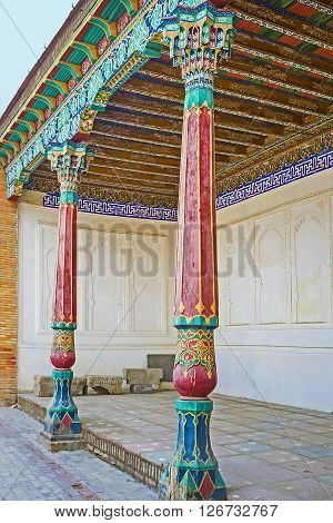 KOKAND UZBEKISTAN - MAY 6 2015: The colorful wooden pillars and carved ceilings are the important details of Eastern mansions like these located in the courtyard of the Khudayar Khan Palace on May 6 in Kokand.