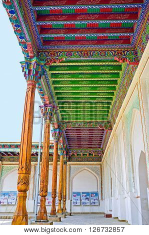 KOKAND UZBEKISTAN - MAY 6 2015: The terrace in the courtyard of Khudayar Khan Palace with the colorful wooden ceiling and slender pillars on May 6 in Kokand.