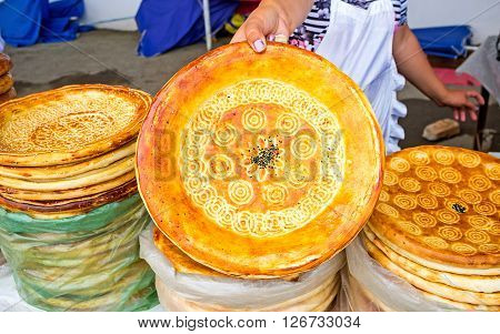 The Uzbek bakers decorate the lochira flat bread with the interesting patterns made with the special chakich stampers Pungan Uzbekistan.