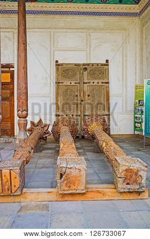 KOKAND UZBEKISTAN - MAY 6 2015: The medieval pillars lying on the floor of Khudayar Khan Palace were remained after restoration as the museum pieces on May 6 in Kokand.