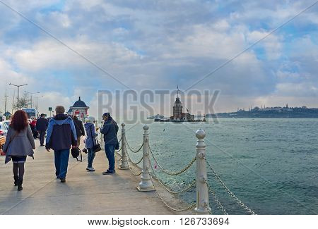 ISTANBUL TURKEY - JANUARY 21 2015: Many tourists visit Uskudar embankment to watch or visit the Maiden's Tower on January 21 in Istanbul.