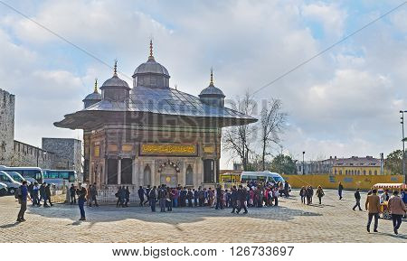 ISTANBUL TURKEY - JANUARY 21 2015: The scenic ablution fountain (sadirvan) in front of the gate of the Topkapi Palace on January 21 in Istanbul.