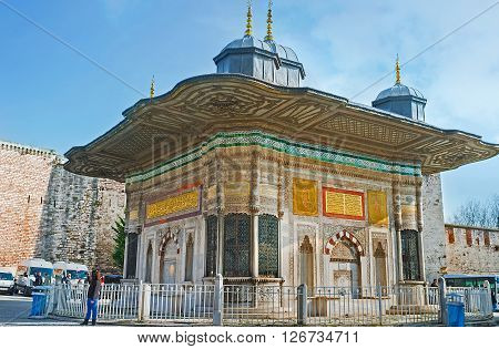ISTANBUL TURKEY - JANUARY 21 2015: The Sadirvan in front of the Royal Gate of Topkapi Palace decorated with the carvings glazed tiles and golden inscriptions from Quran on January 21 in Istanbul.