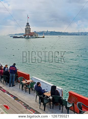 ISTANBUL TURKEY - JANUARY 21 2015: The outdoor teahouse on the Uskudar embankment is the best place to relax with a view on the Maiden's Tower on January 21 in Istanbul.