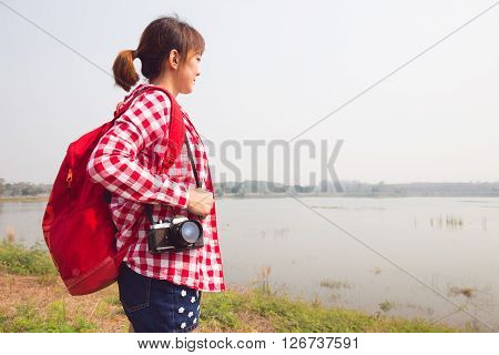 young woman girl is travel with backpack and camera. travel concept