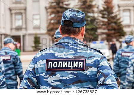 Russian policeman in uniform. Text in russian: "Police"