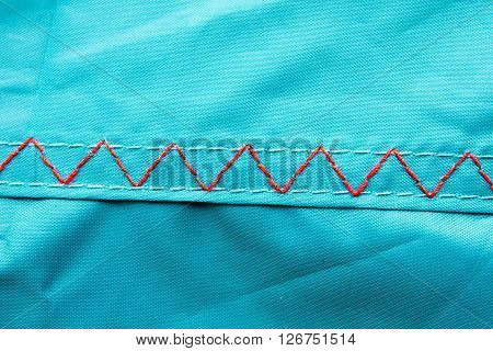 Thread stitching on a camping tent closeup.