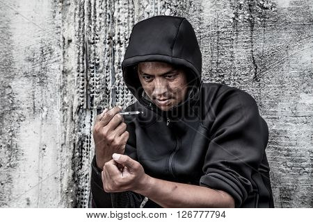 overdose asian male drug addict hand drugs narcotic syringe in action