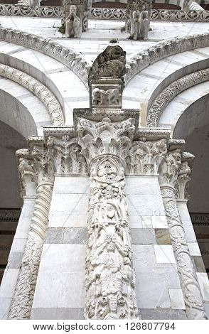 Lucca cathedral facade detali with marble columns and archs