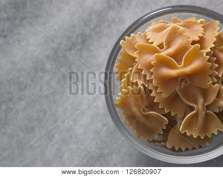 dry farfalloni pasta on the marble top