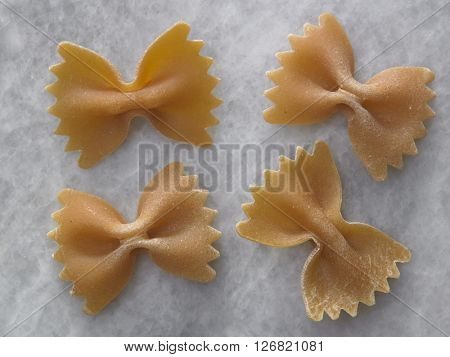 dry farfalloni pasta on the marble top