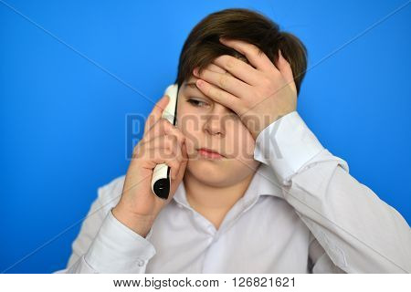 Upset teenage boy talking by a radiotelephony