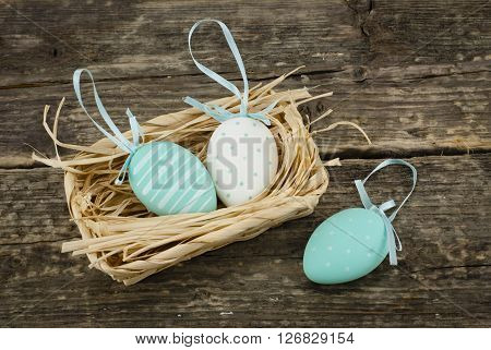 Colorful decorative eggs in the basket top view