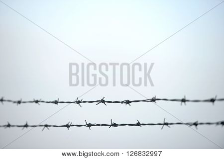 Double horizontal barb wire fence, center sharp