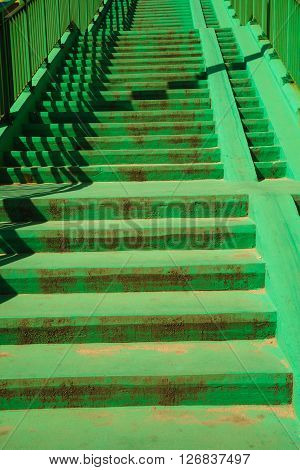 Green concrete stairs stairway with railing handrail on sunny day. Architecture. Urban scene.