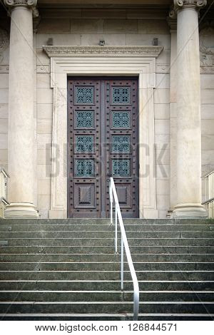 MAINZ, GERMANY - APRIL 07: The entrance of the old crematory in the main cemetery of the city of Mainz with a heavy iron-studded wooden door on April 07 2016 in Mainz.