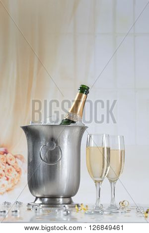 Glasses of champagne and bottle with festive background