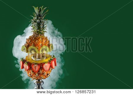 Smoking hookah with fruit head on dark background