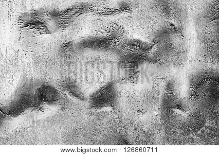 the abstract textured background of a bumpy surface of gray graphite color