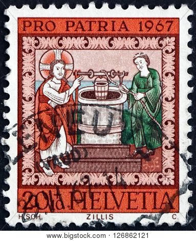 SWITZERLAND - CIRCA 1967: a stamp printed in the Switzerland shows Jesus and the Samaritan Woman at the Well circa 1967