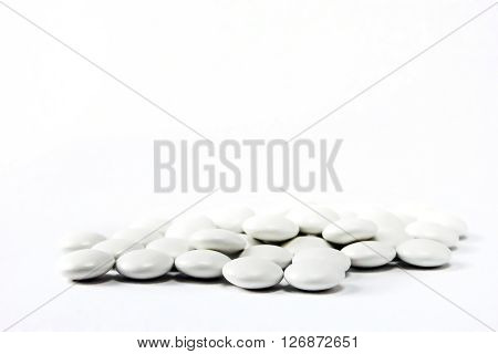 handful of tablets closeup isolated on white background