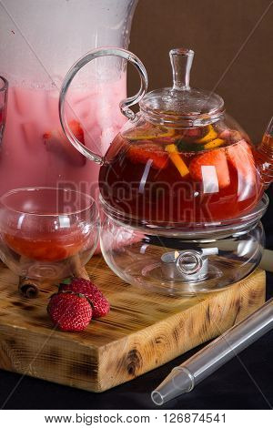 still life of a hookah , tea mainly in red tones .
strawberries