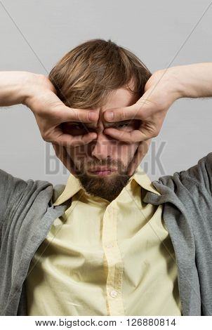 portrait of amazed man against grey wall background