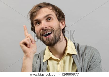 Young smiling man having a good idea