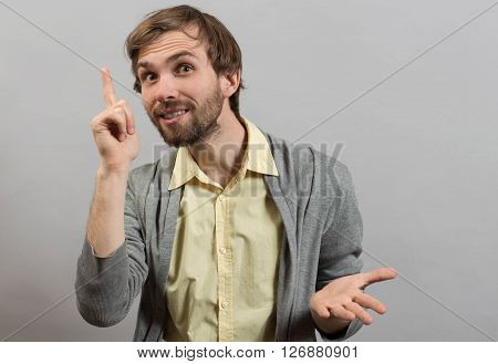 young man pointing up, showing something, having an idea