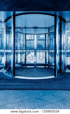 Revolving door ,blue toned image.