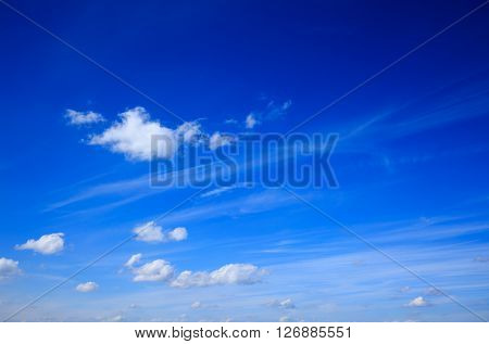 Some small white clouds spreaded over a bright blue sky