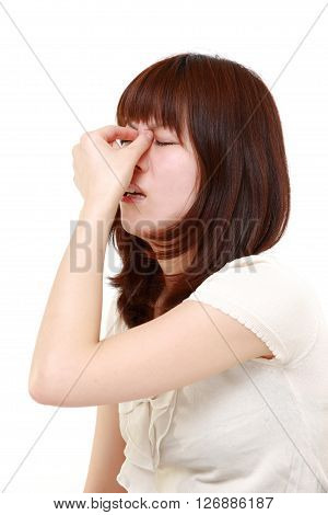 portrait of young Japanese woman suffers from Asthenopia