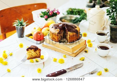 Traditional homemade chocolate cake. Rustic style and natural light. Chocolate Mud Cake on White table. Piece of chocolate cake with icing. Vanilla Cake with Chocolate Glaze.