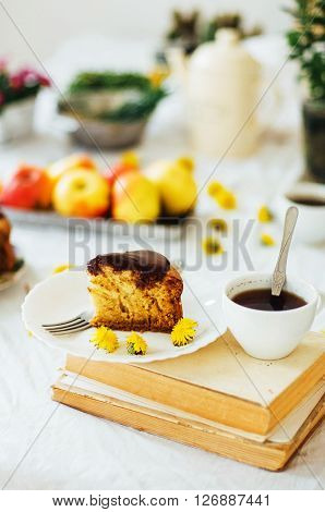 Traditional homemade chocolate cake. Rustic style and natural light. Chocolate Mud Cake on White table. Piece of chocolate cake with icing. Vanilla Cake with Chocolate Glaze.