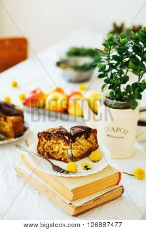 Traditional homemade chocolate cake. Rustic style and natural light. Chocolate Mud Cake on White table. Piece of chocolate cake with icing. Vanilla Cake with Chocolate Glaze.