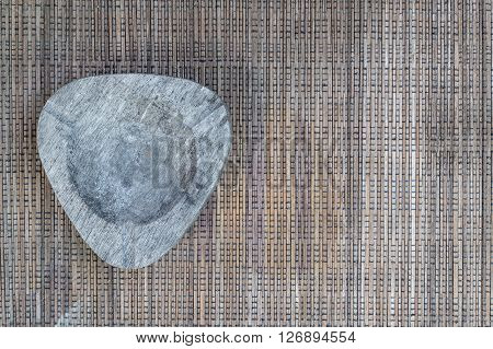 Empthy ashtray on brown woven cloths on the left side