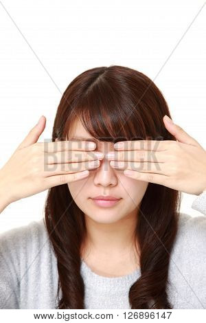 young Japanese womanwoman covering her face with hands