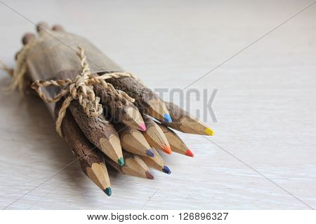 Wooden pencils on a white wooden table.