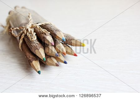 Wooden pencils on a white wooden table.