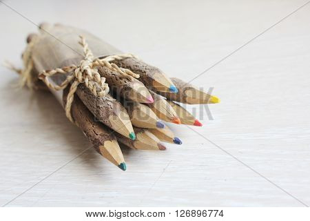 Wooden pencils on a white wooden table.