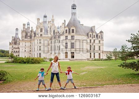 Mother And Two Children, Boys Brothers, Holding Hands In Front Of The Chambord Castle