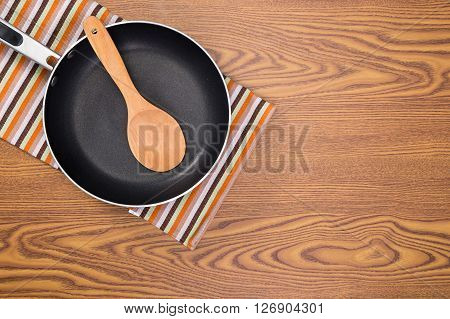 non stick frying pans on wooden background
