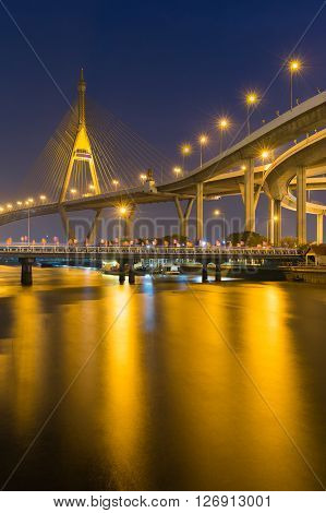 Twilight over Suspension Bridge and lights reflection
