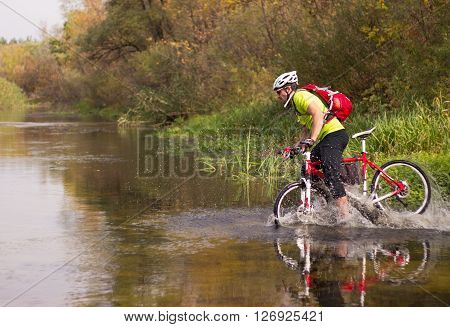 Male cyclist traveling with bike and backpack.