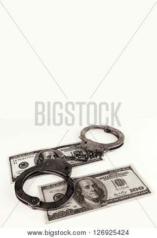 fake dollars with handcuffs isolated on white background.