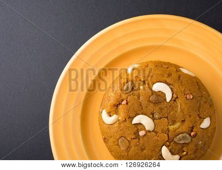 Moong Dal Halwa - a sweet dish from India, Indan Sweet Halwa made from Moong Dal, moong dal sweet sheera or shira cooked in pure ghee, served in a yellow ceramic plate