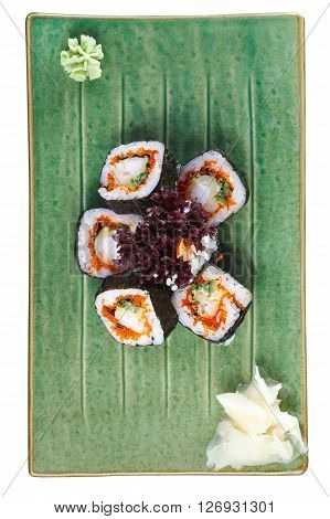 Sushi rolls with tuna and flying fish roe on a plate with wasabi and ginger. Top view. Isolated on white background. Include clipping path.