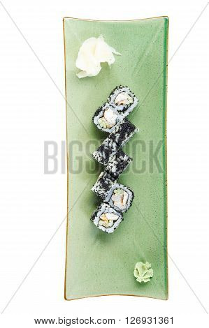 Sushi rolls with tuna and flying fish roe on a plate with wasabi and ginger. Top view. Isolated on white background. Include clipping path.